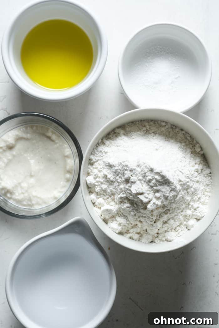 A visual representation of the core ingredients: flour, sourdough starter, and olive oil, ready for mixing.