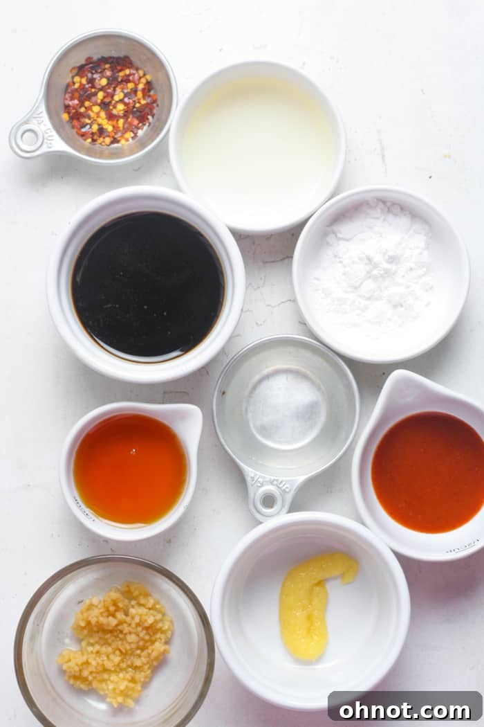 Close-up of fresh soy sauce and an assortment of spices, including ginger and garlic, laid out for Korean BBQ sauce preparation.