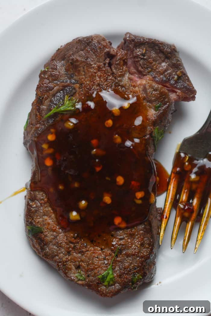 Grilled steak pieces drizzled with homemade Korean sauce, presented beautifully.