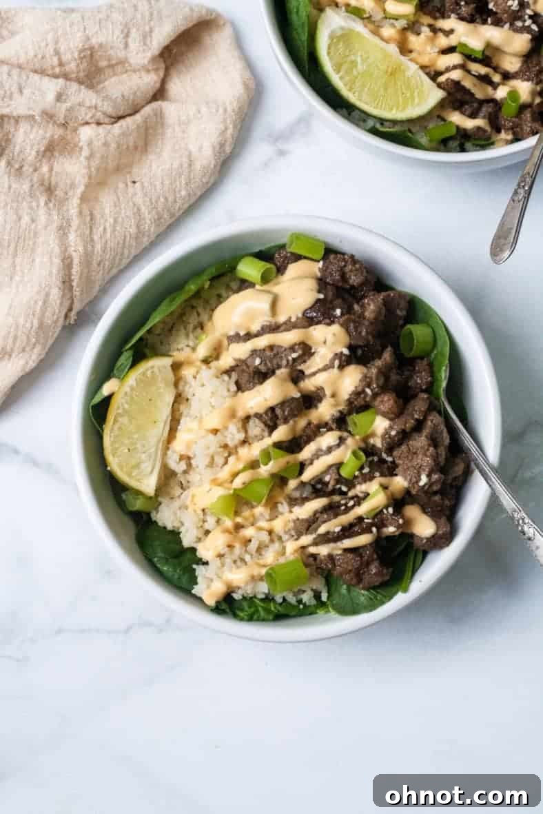 Finished Whole30 Korean Beef Bowls on a table, garnished and ready to be enjoyed.