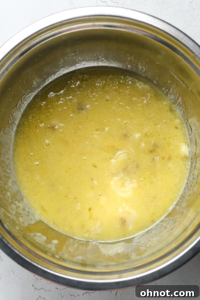 Eggs and oil being mixed in a bowl.