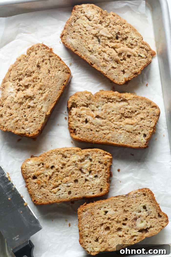 Slices of soft, fluffy sourdough banana bread on a cooling rack.