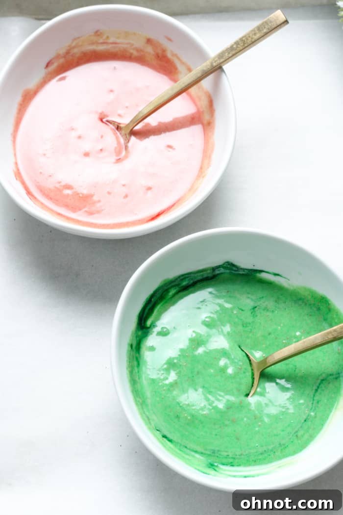Two bowls, one with red-tinted white chocolate and the other with green-tinted white chocolate.