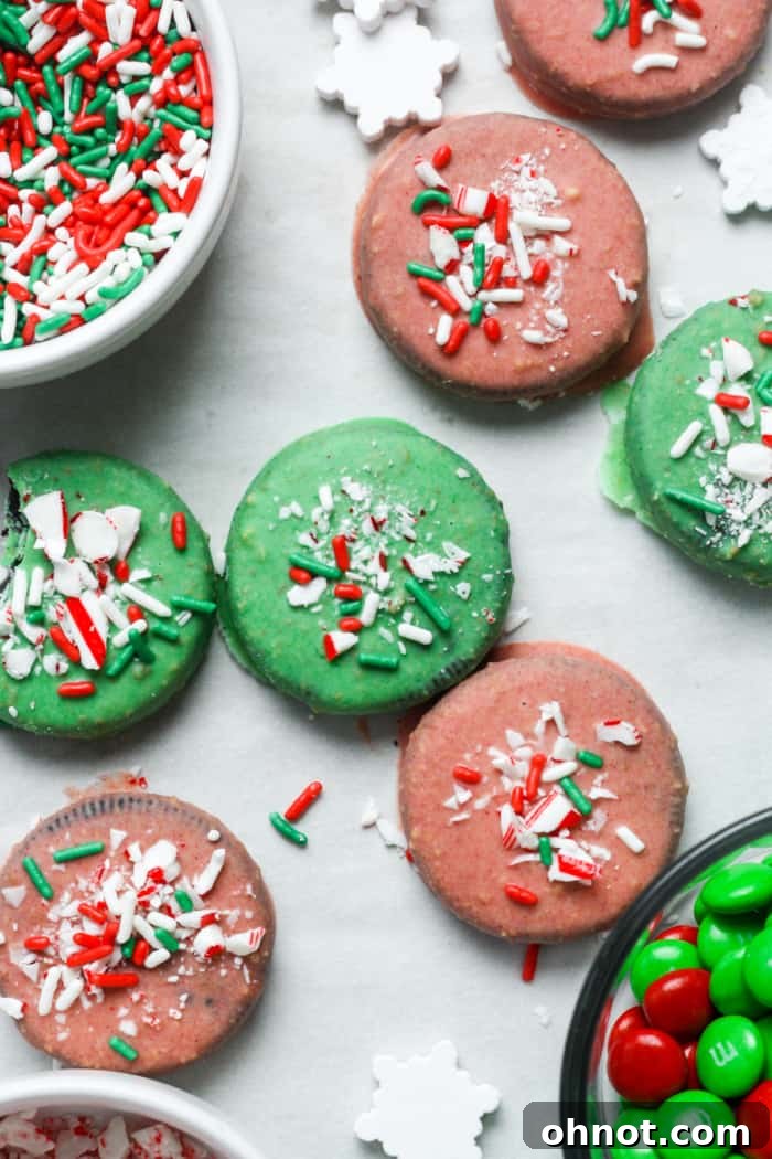 A spread of red and green decorated chocolate cookies with various festive sprinkles.