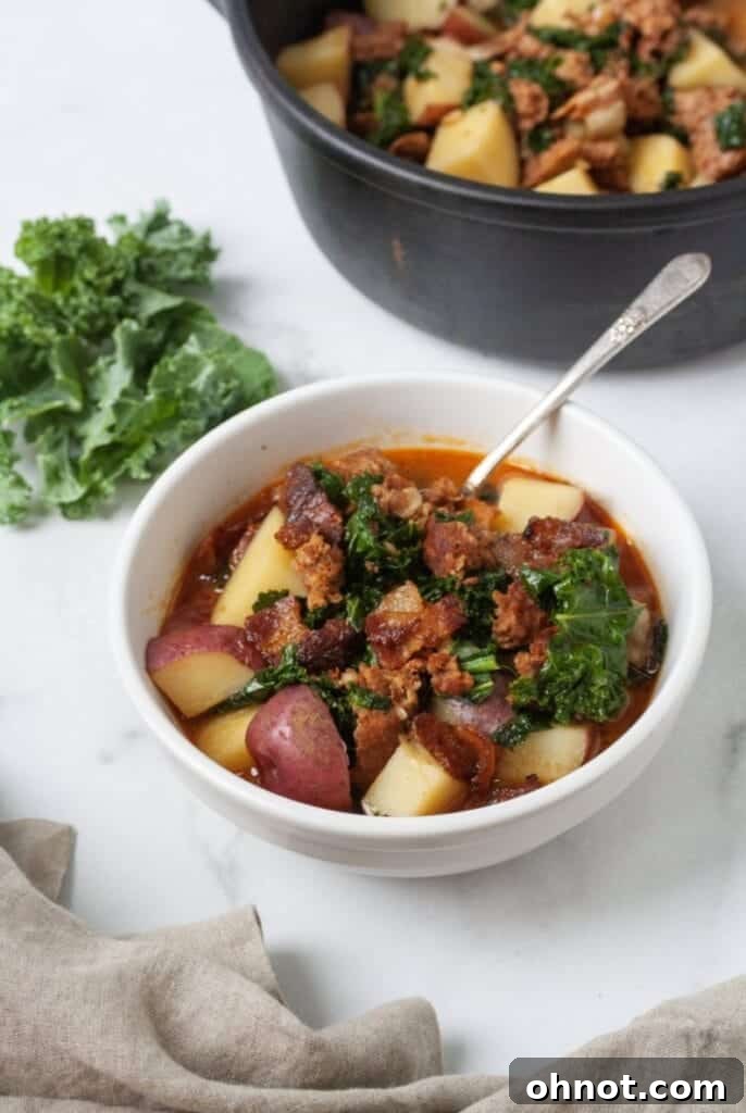 Paleo soup with chorizo and potatoes in a rustic bowl.