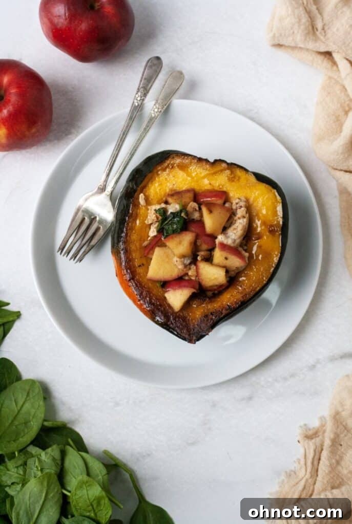 A single serving of Whole30 stuffed acorn squash on a white plate, garnished and ready to eat.