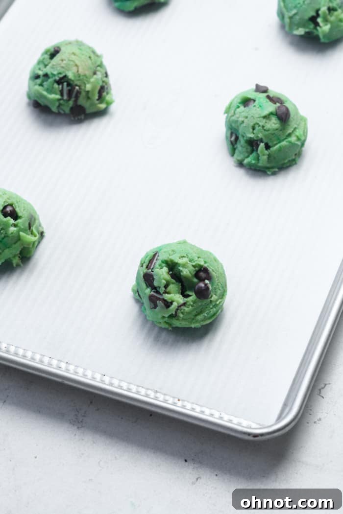 Scooped mint dough balls on a baking sheet.
