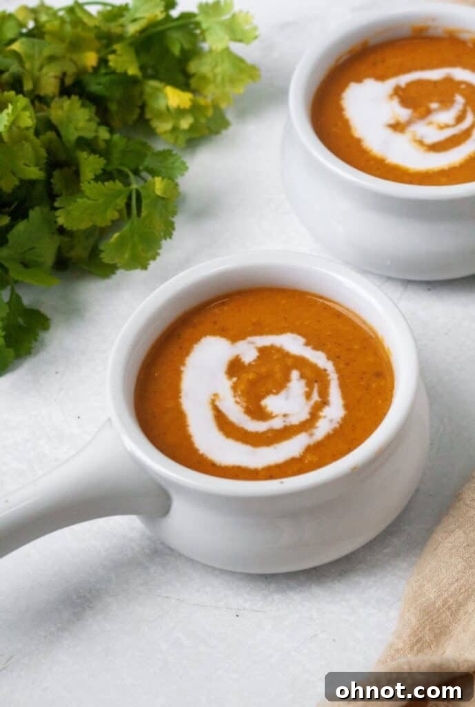 Close-up of creamy Paleo soup with a swirl of coconut milk.
