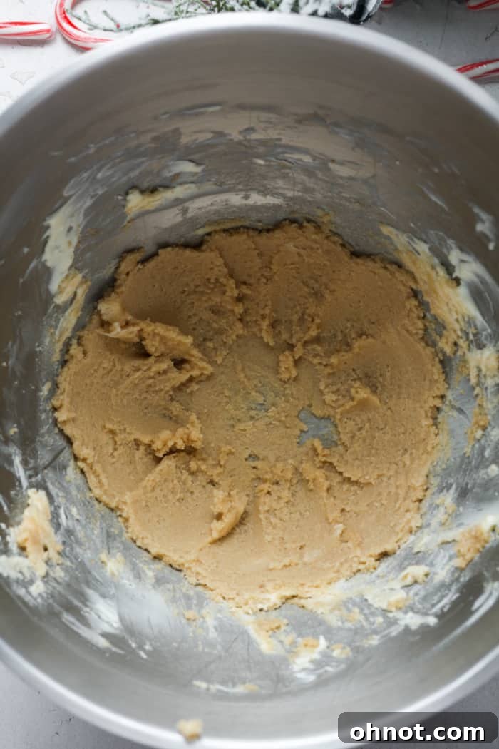 Creamed butter and sugar in a mixing bowl, showing a light and fluffy texture.