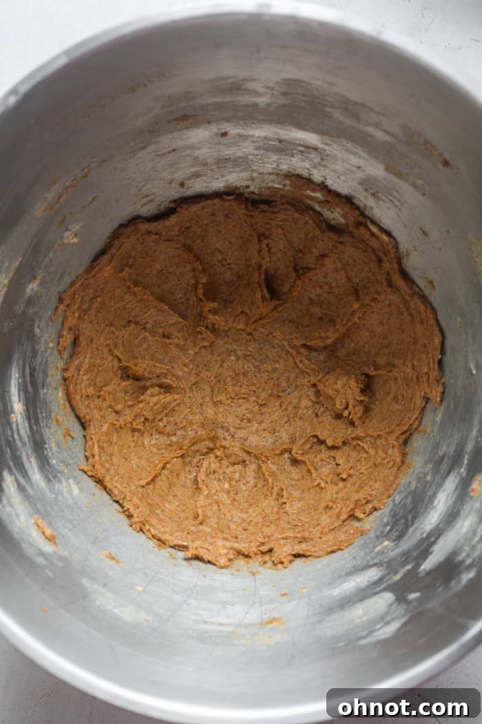 Cold butter and coconut sugar being creamed in a stand mixer.