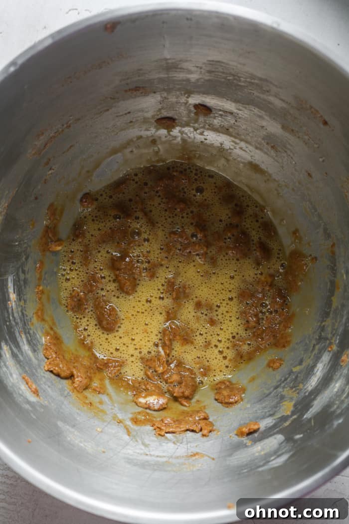 Eggs and vanilla extract mixed into coconut sugar and butter.