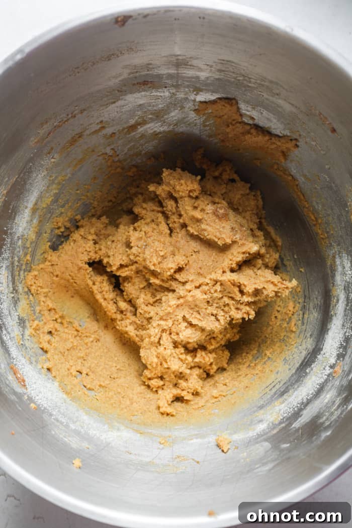 Thick healthy cookie dough forming in the mixing bowl.