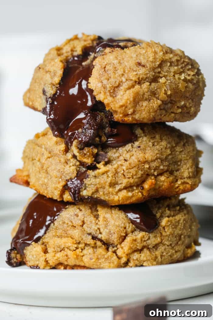 Stack of melted chocolate chunk cookies.