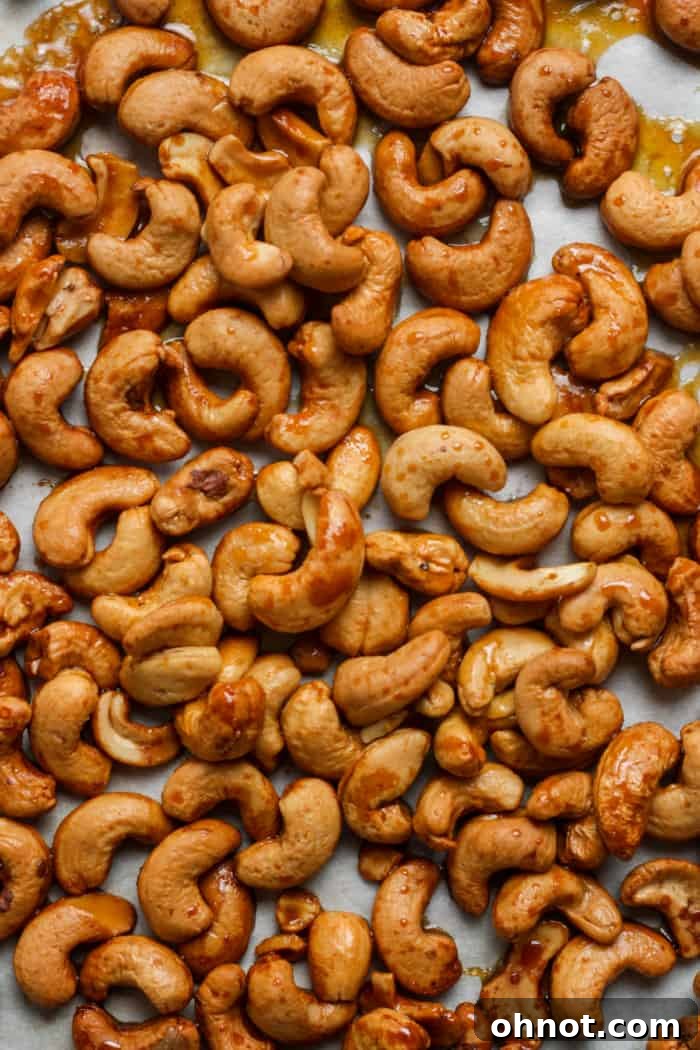 Irresistibly golden honey roasted cashews, perfectly sweet and salty, piled in a rustic bowl.