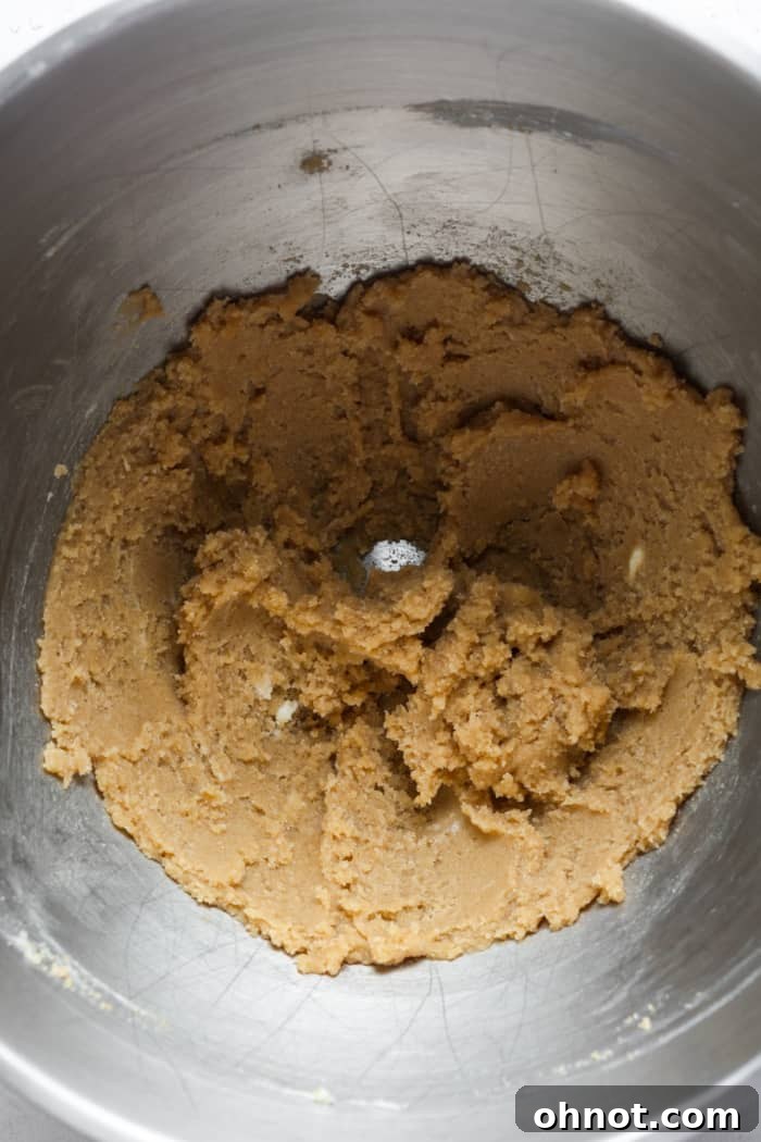 Dark sugar and butter in bowl. Cold butter cubes and brown sugar in a stand mixer bowl.