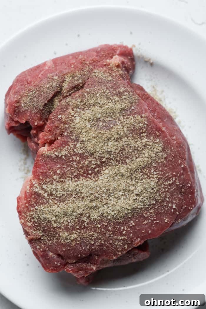 Filet mignon generously seasoned with sea salt and black pepper.