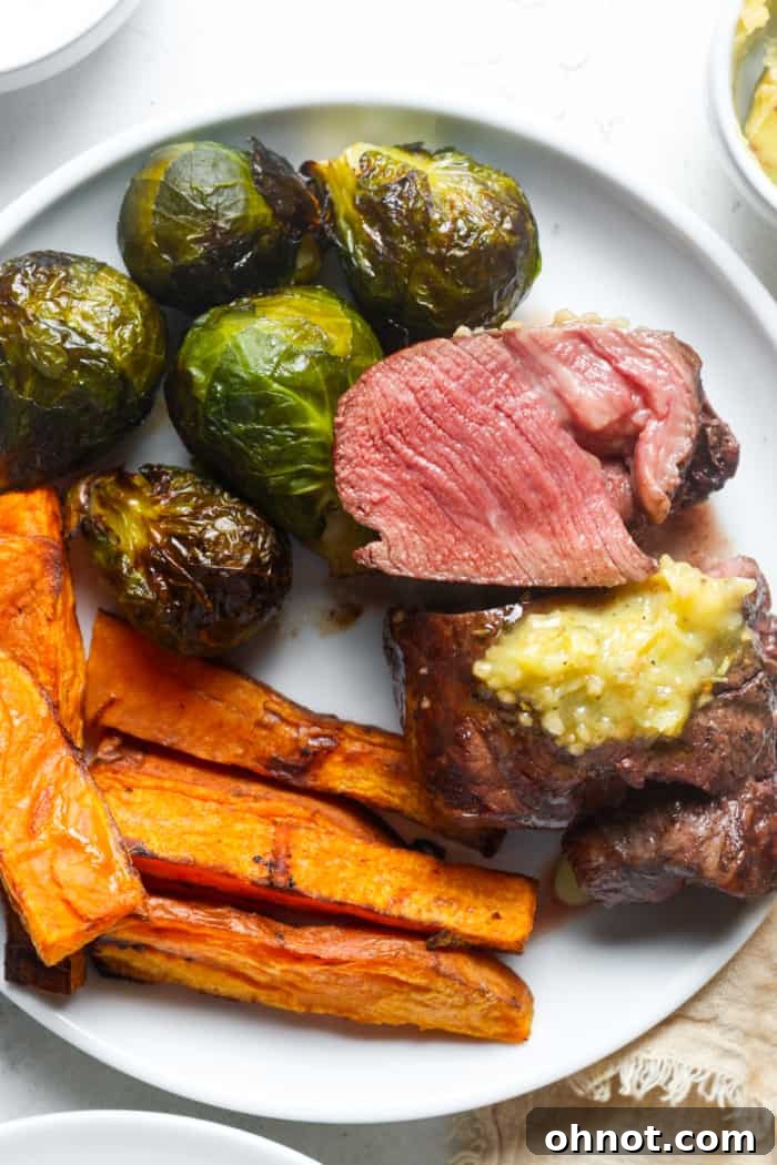 A perfectly cooked medium-rare steak on a plate, showing its juicy interior.