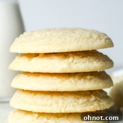 A plate of freshly baked vegan sugar cookies, some frosted and some plain.