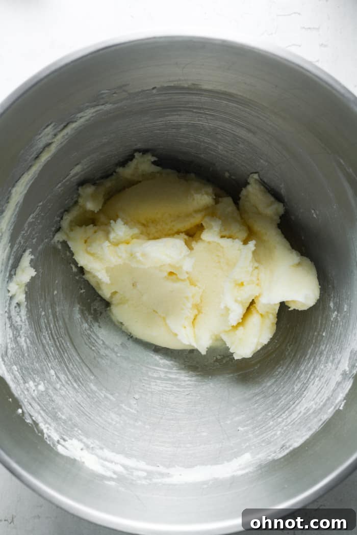 Cold vegan butter, brown sugar, and white sugar in a stand mixer bowl.