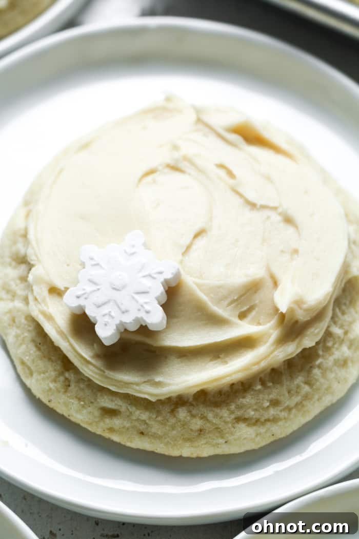 Thick, piped vegan buttercream frosting on a golden-brown cookie, ready to eat.