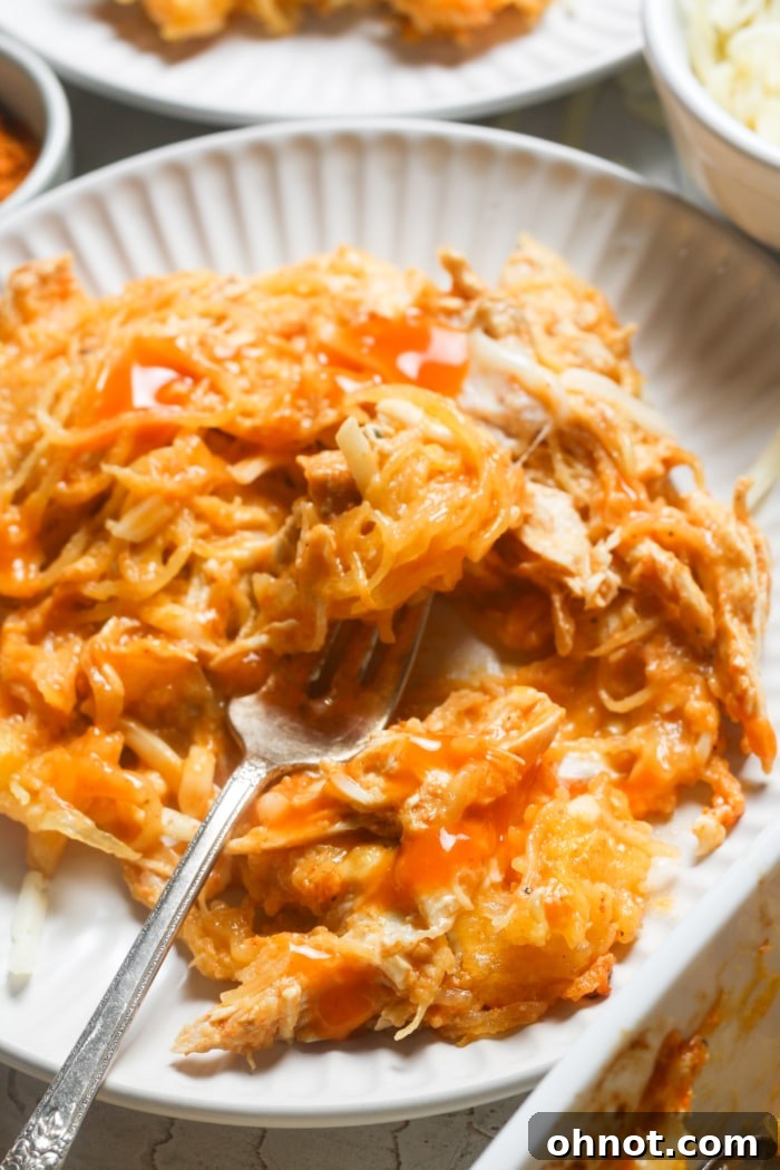 A close-up of creamy spaghetti squash with buffalo chicken, perfectly seasoned, garnished, and ready to be enjoyed.