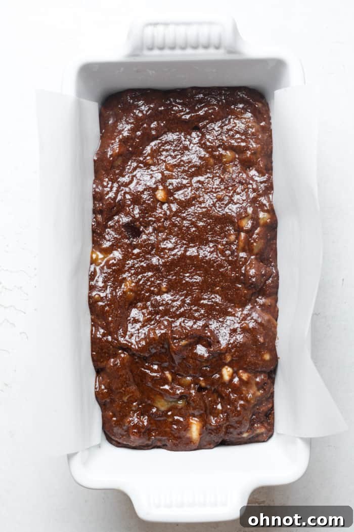 Loaf pan with chocolate batter.