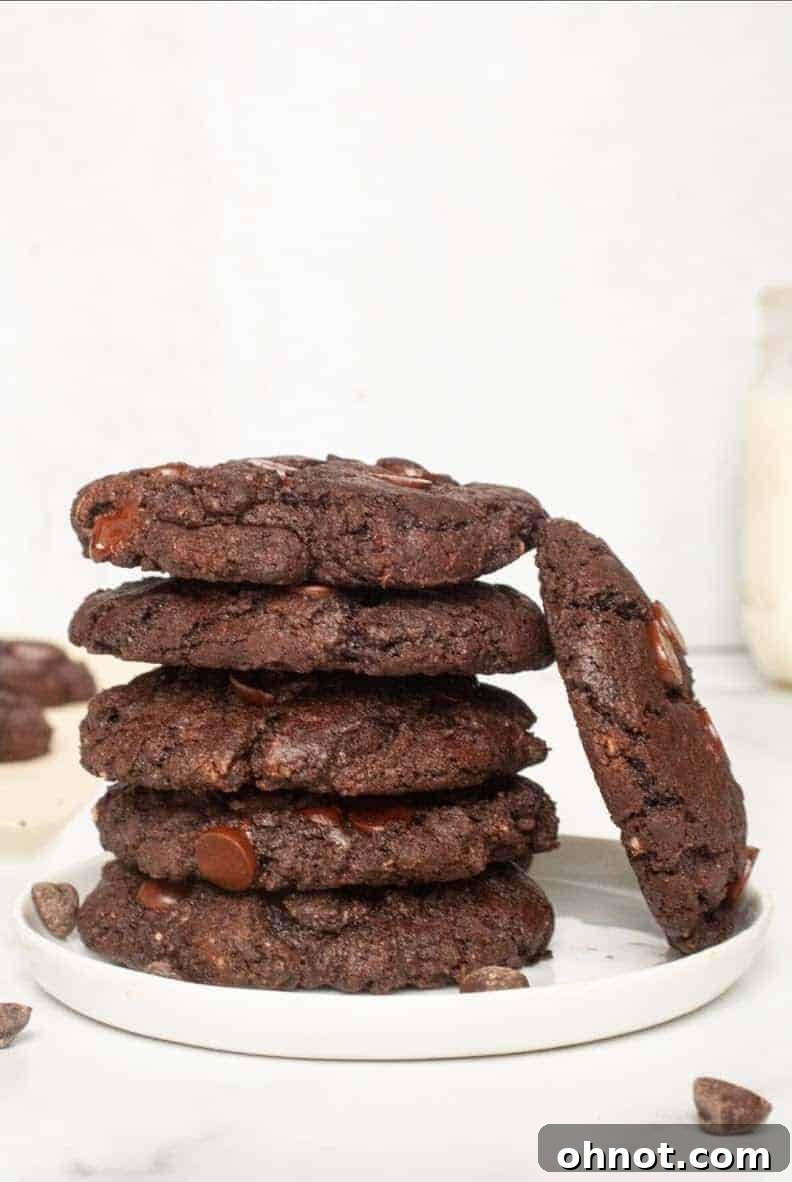A stack of freshly baked Double Chocolate Cookies on a cooling rack, highlighting their rich color and delicious texture.