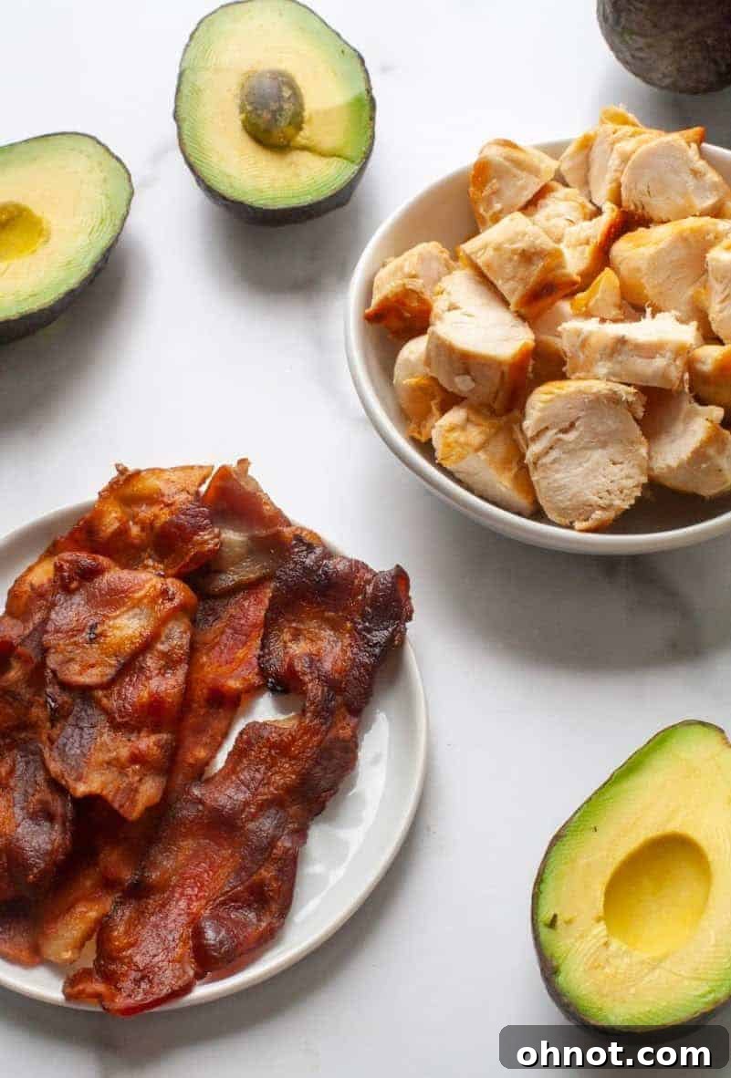 Final Whole30 Avocado Chicken Salad in a bowl, garnished with basil