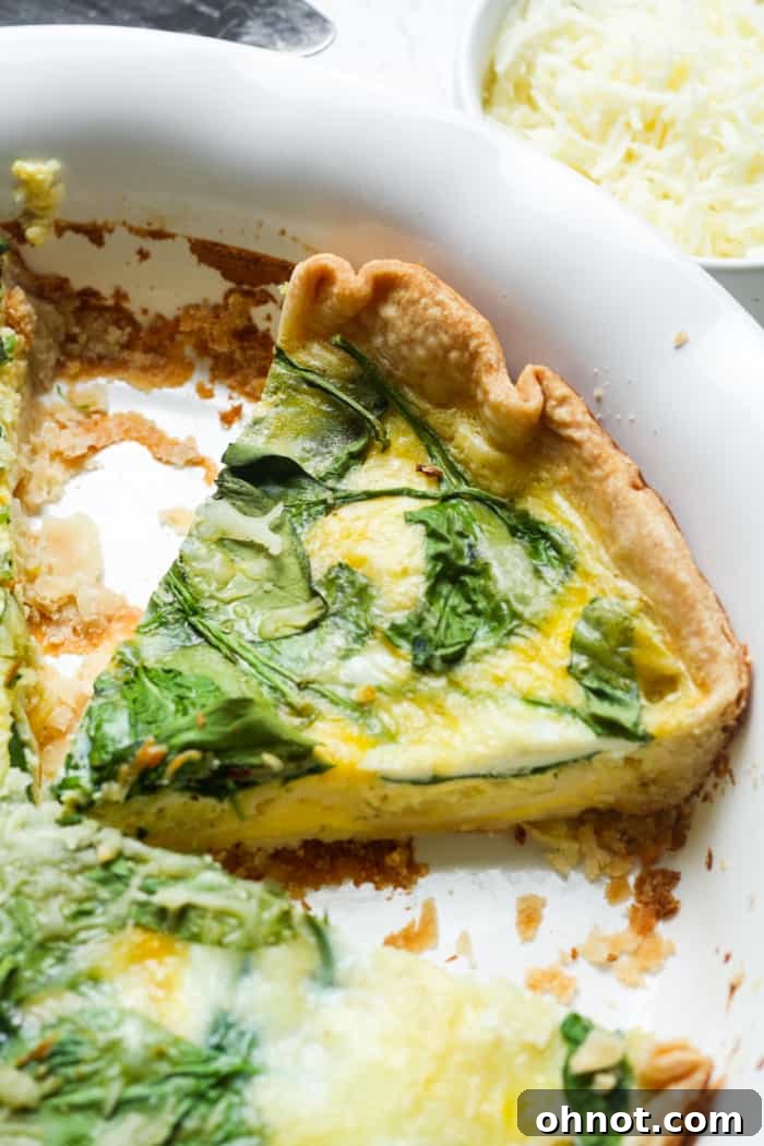 Quiche Florentine, showcasing a beautiful golden-brown crust and a creamy spinach and cheese filling, ready to be served.