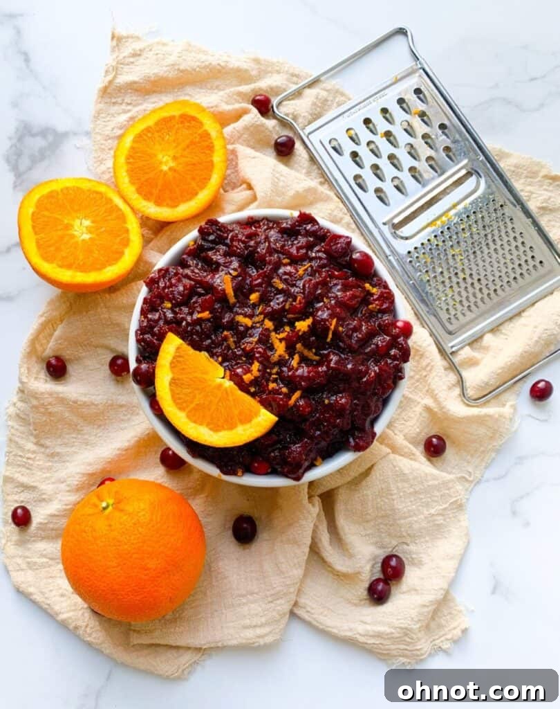 Paleo cranberry sauce garnished with fresh orange slices, emphasizing its natural ingredients