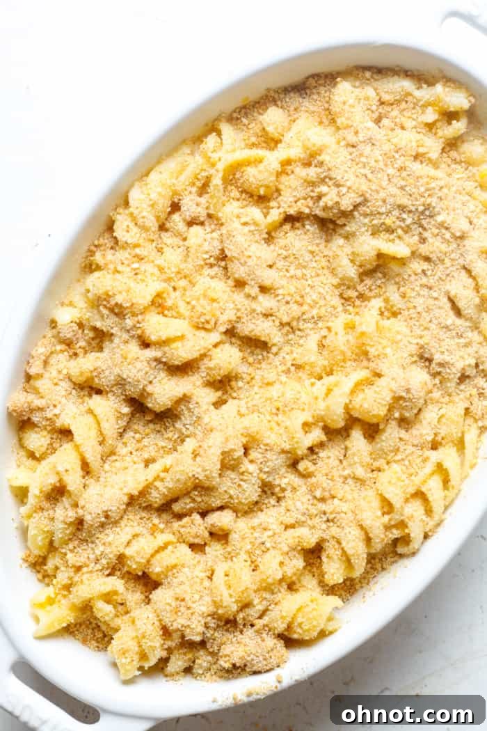 Homemade comfort food, specifically mac and cheese, in a baking dish with breadcrumbs sprinkled on top.