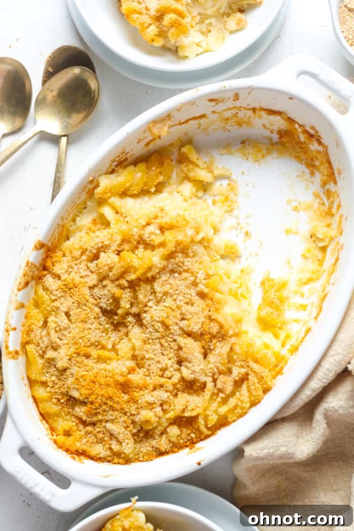A close-up shot of baked mac and cheese, showing its golden crust and creamy interior.