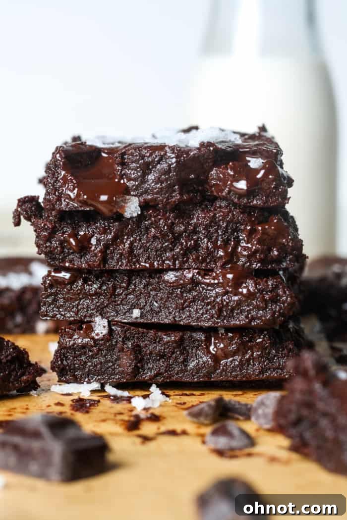Stack of fudgy, healthier brownies garnished with sea salt.