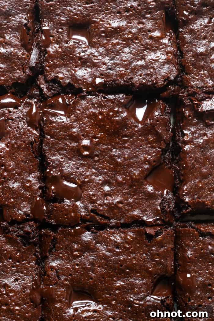 Healthier fudgy brownies cut into squares, ready to serve.