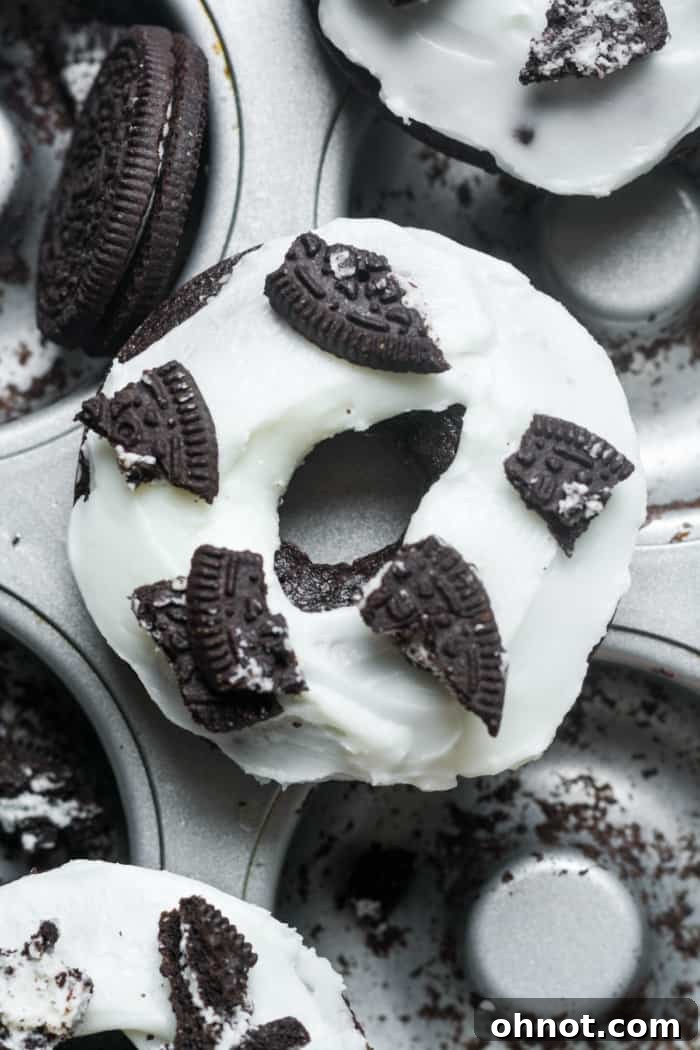 Freshly baked Oreo donuts with creamy vanilla frosting and crushed Oreos on top.