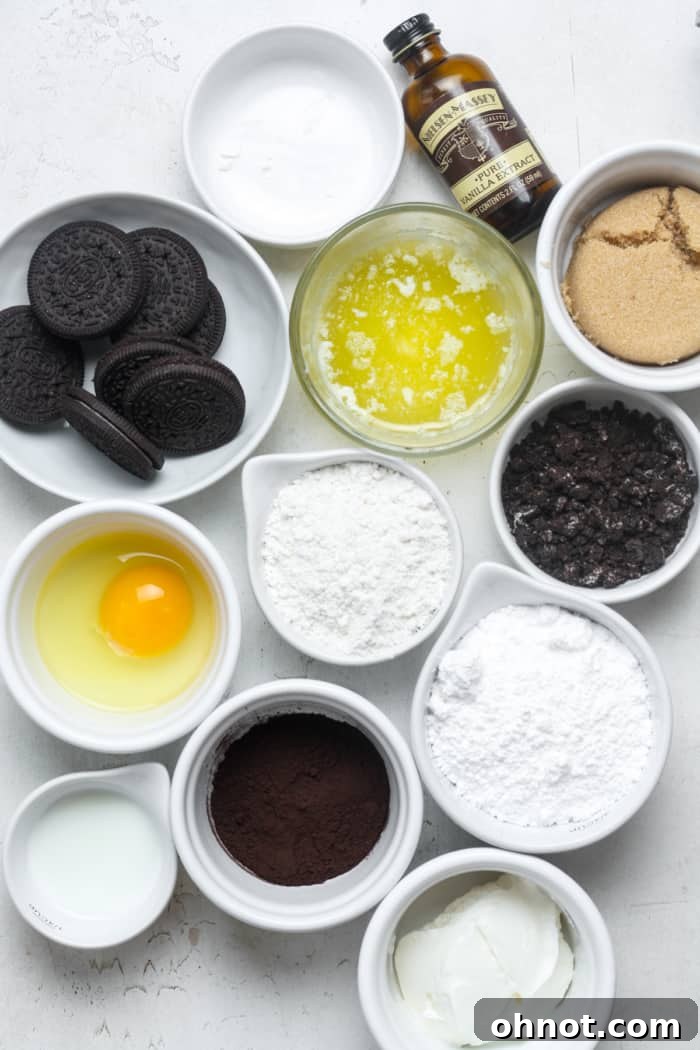 Various ingredients for making Oreo donuts laid out on a clean surface.