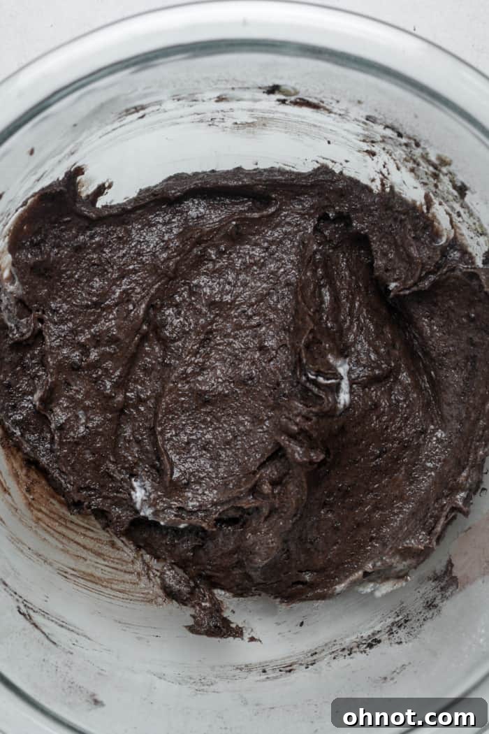 Thick, rich Oreo donut batter, showcasing the texture and crushed cookie pieces.