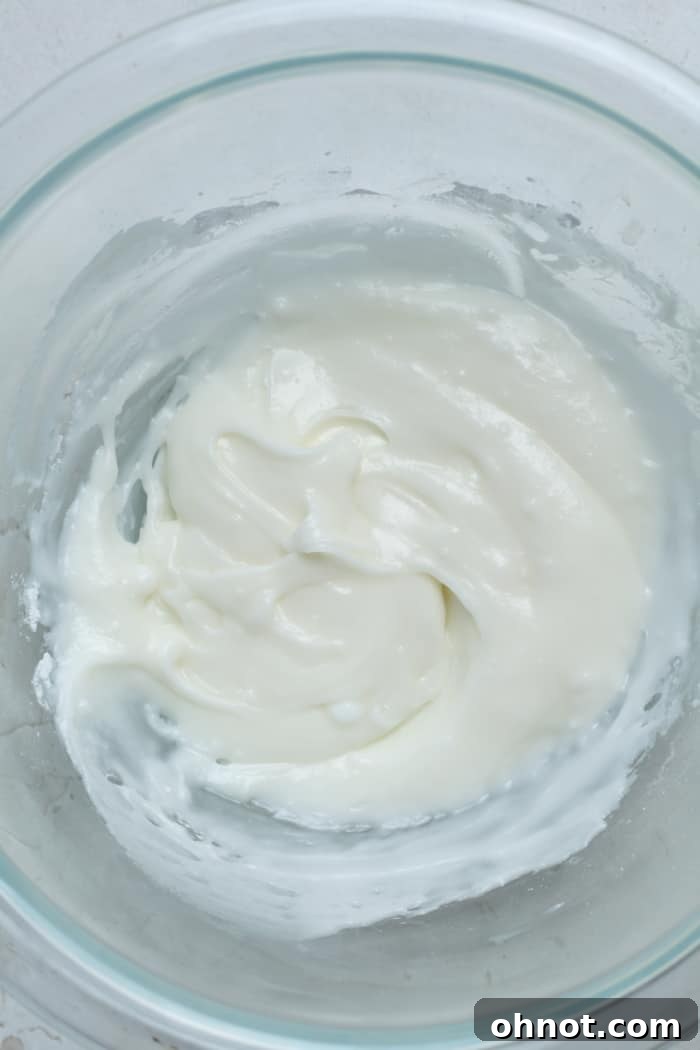 Smooth, creamy vanilla icing in a small mixing bowl, ready for frosting.
