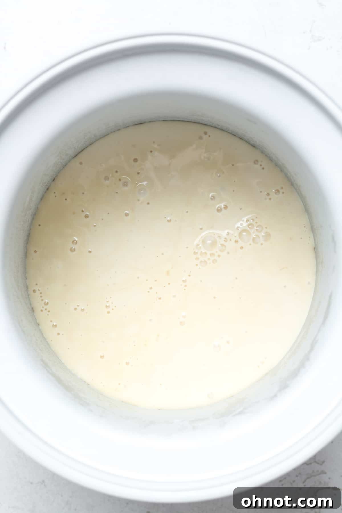 Ice cream mixture churning in an ice cream maker.