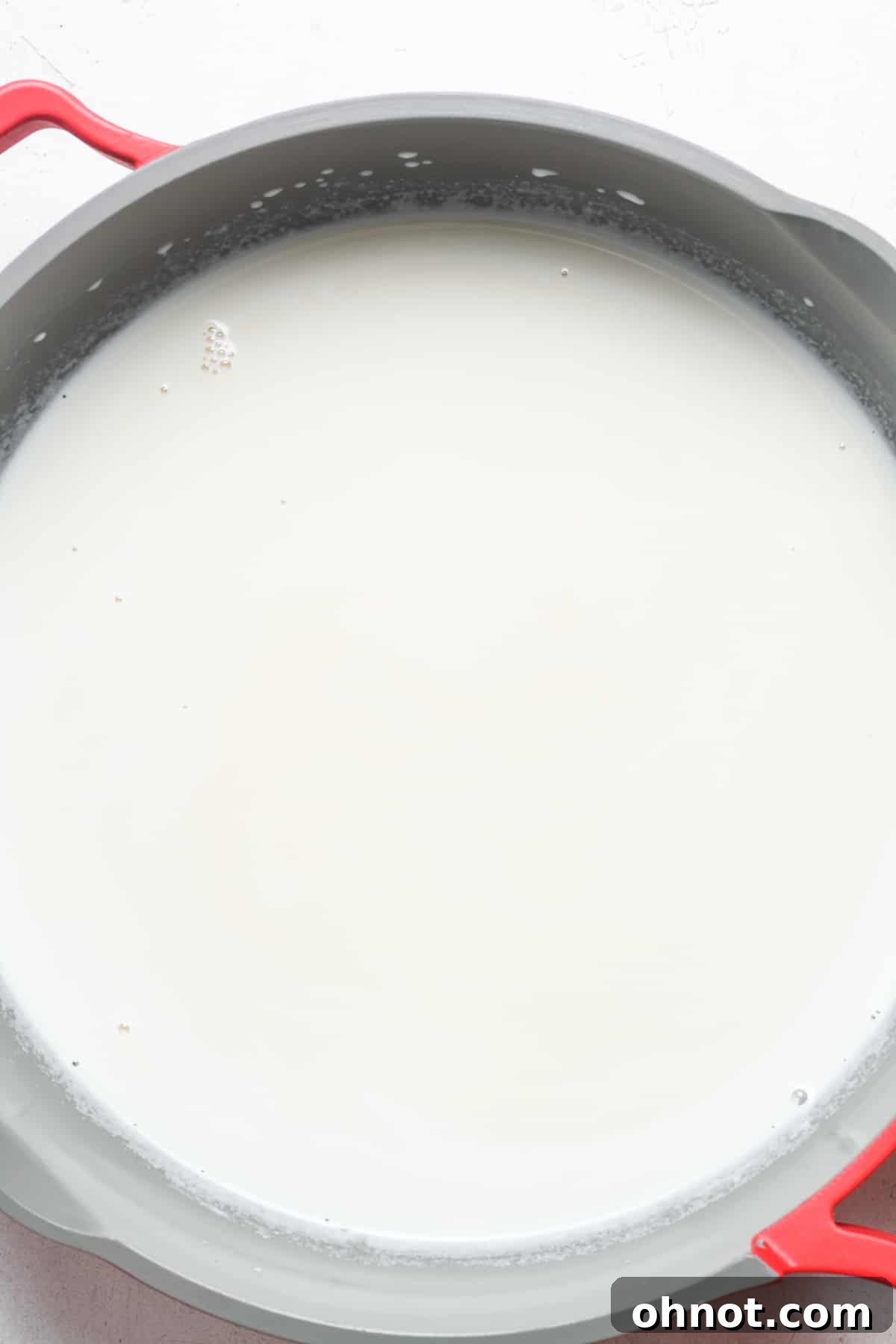 Sugar dissolved in warm cream in a skillet.
