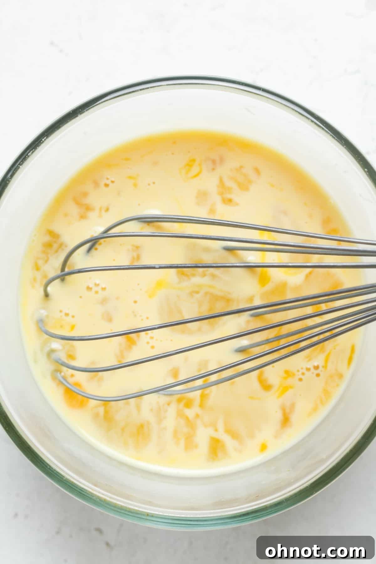 Whisked eggs in a mixing bowl.