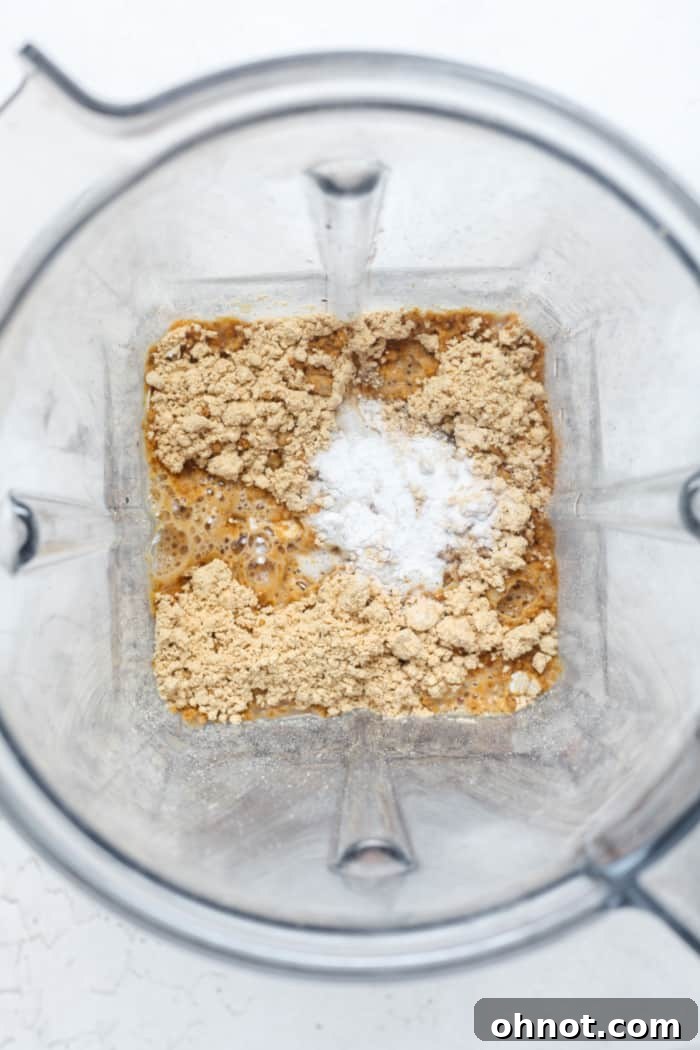 Blender with oats and protein powder before blending.