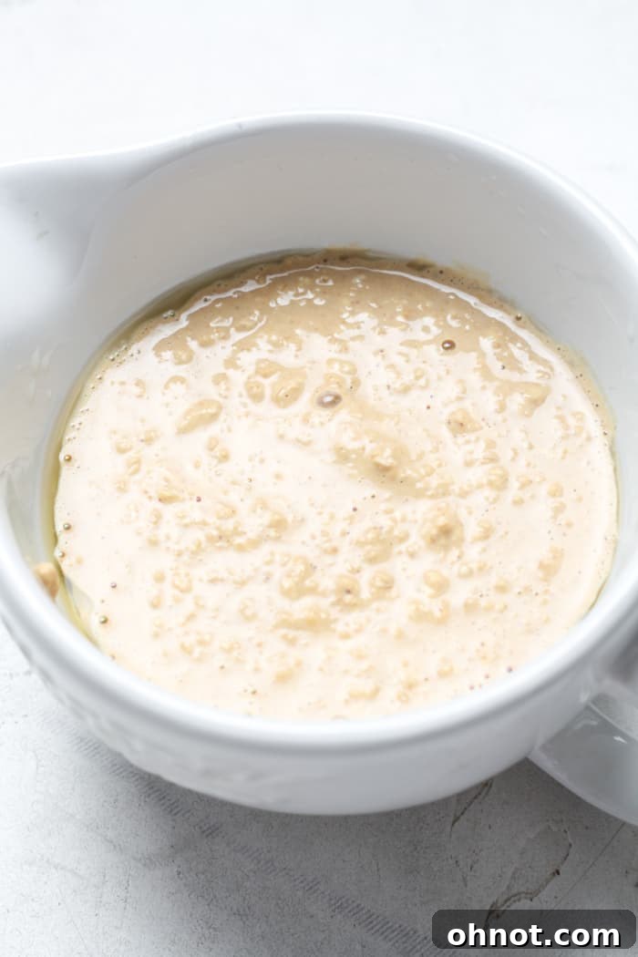 Raw oat batter poured into a cup.