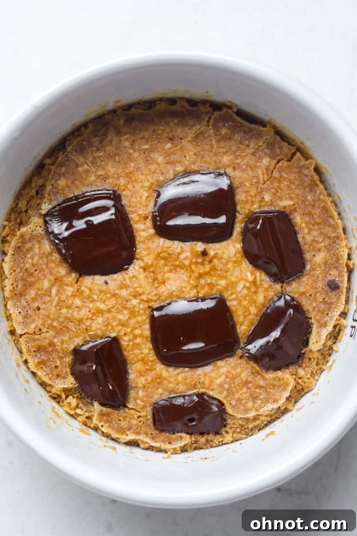 Baked batter in a cup, golden brown on top.