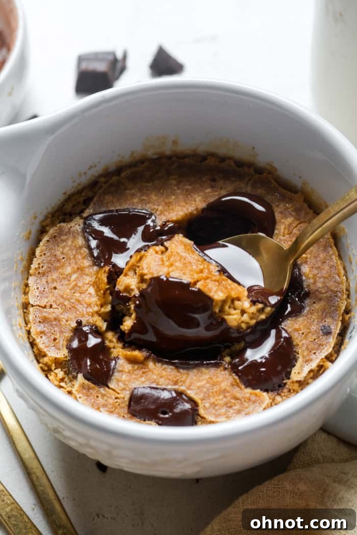 Gooey blended oatmeal in a ramekin after baking, with melted chocolate.