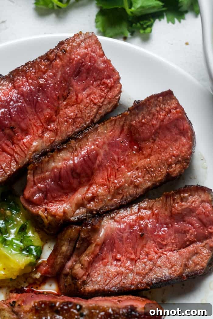 Perfectly cooked Denver steak, sliced and ready to serve.