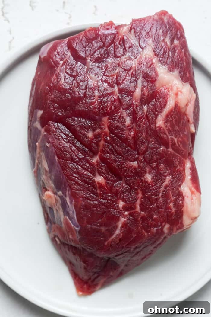 Raw Denver steak on a cutting board, ready for seasoning.