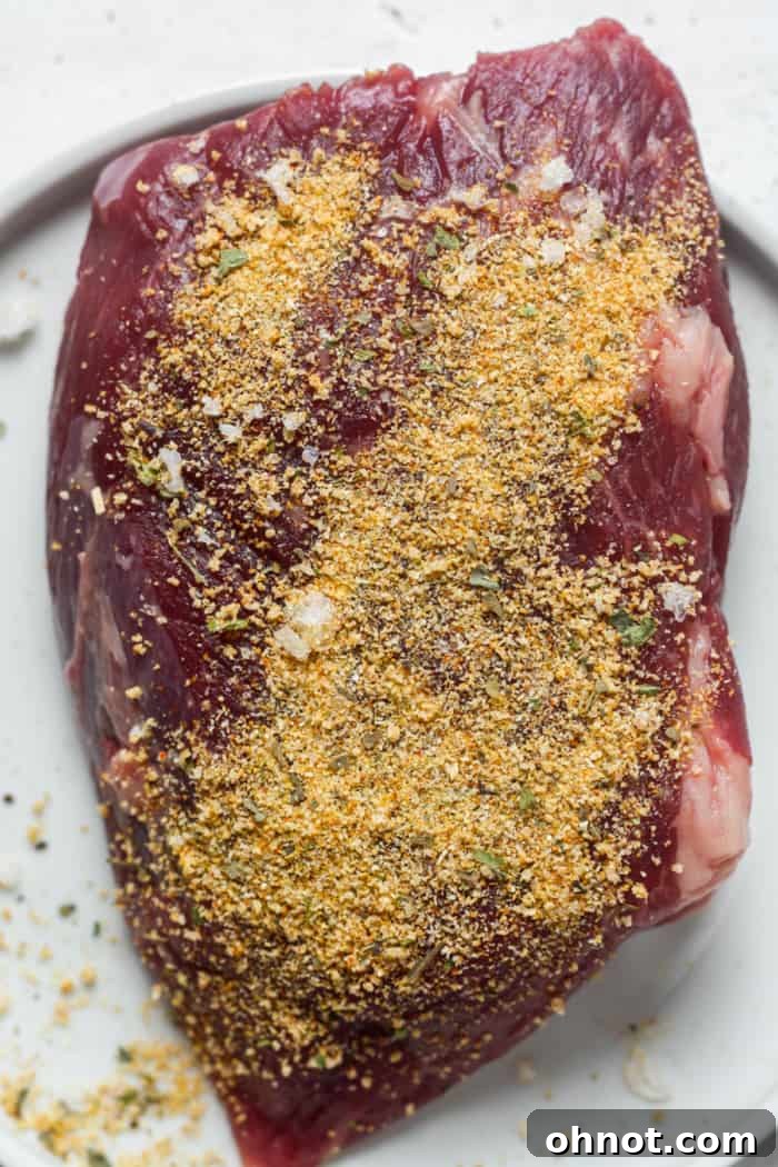 Seasoned Denver steak on a plate, ready for the pan.