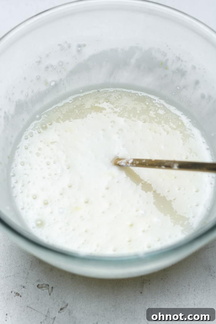 Smooth, white lemon glaze in a small bowl.