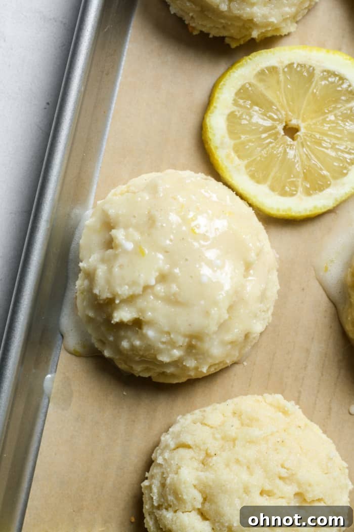 Beautifully glazed lemon ricotta cookies on a wire rack.